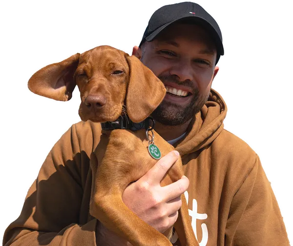 Jack, Canilabs' founder, smiling and holding Ives as a puppy