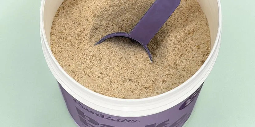 Scoop of Bark Biotic powder in an open tub